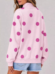 Back view of pink mock neck oversized sweatshirt with large magenta polka dots on model