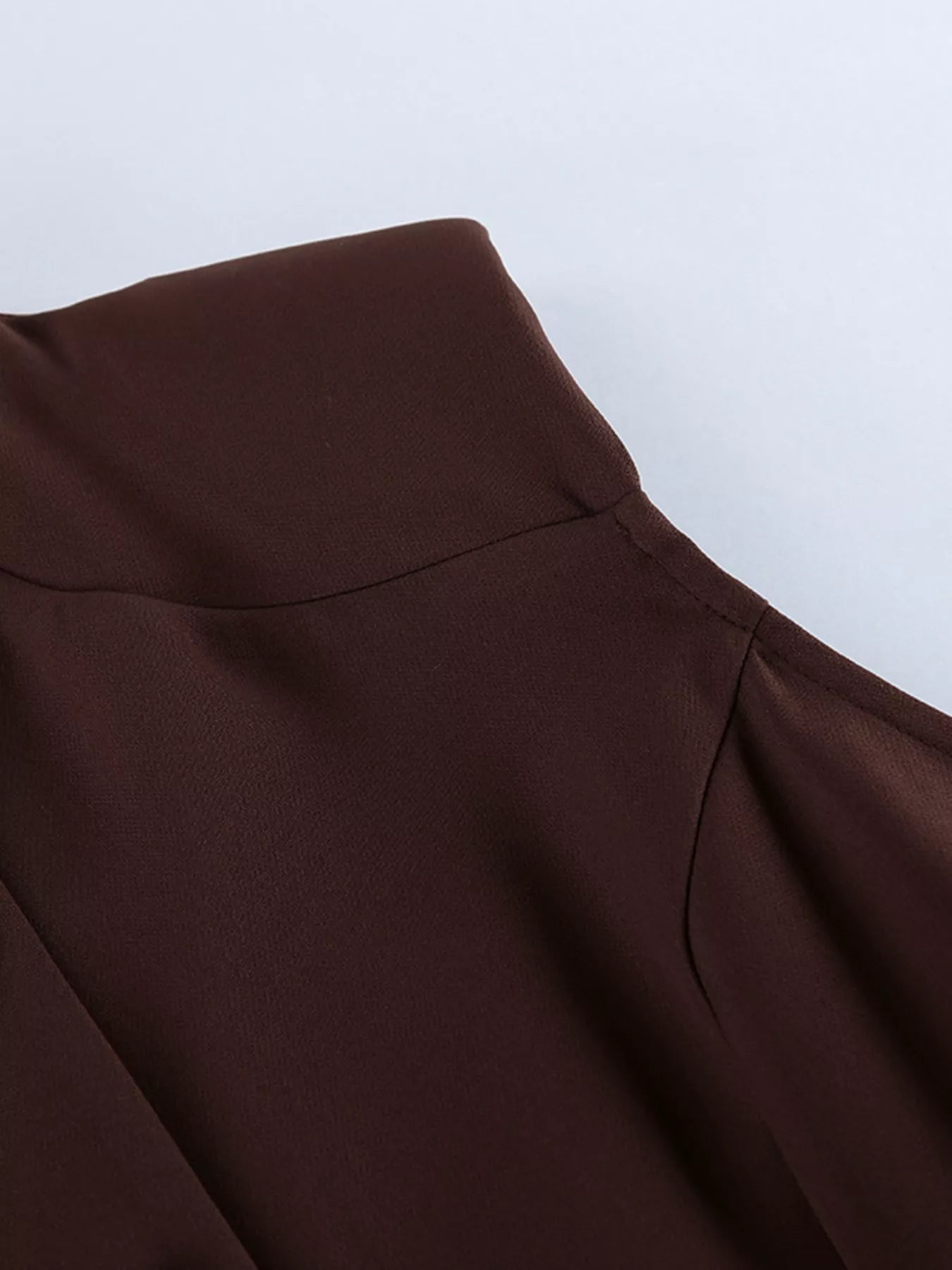 Brown button down mini dress detail showing collar seam and shoulder stitching flat