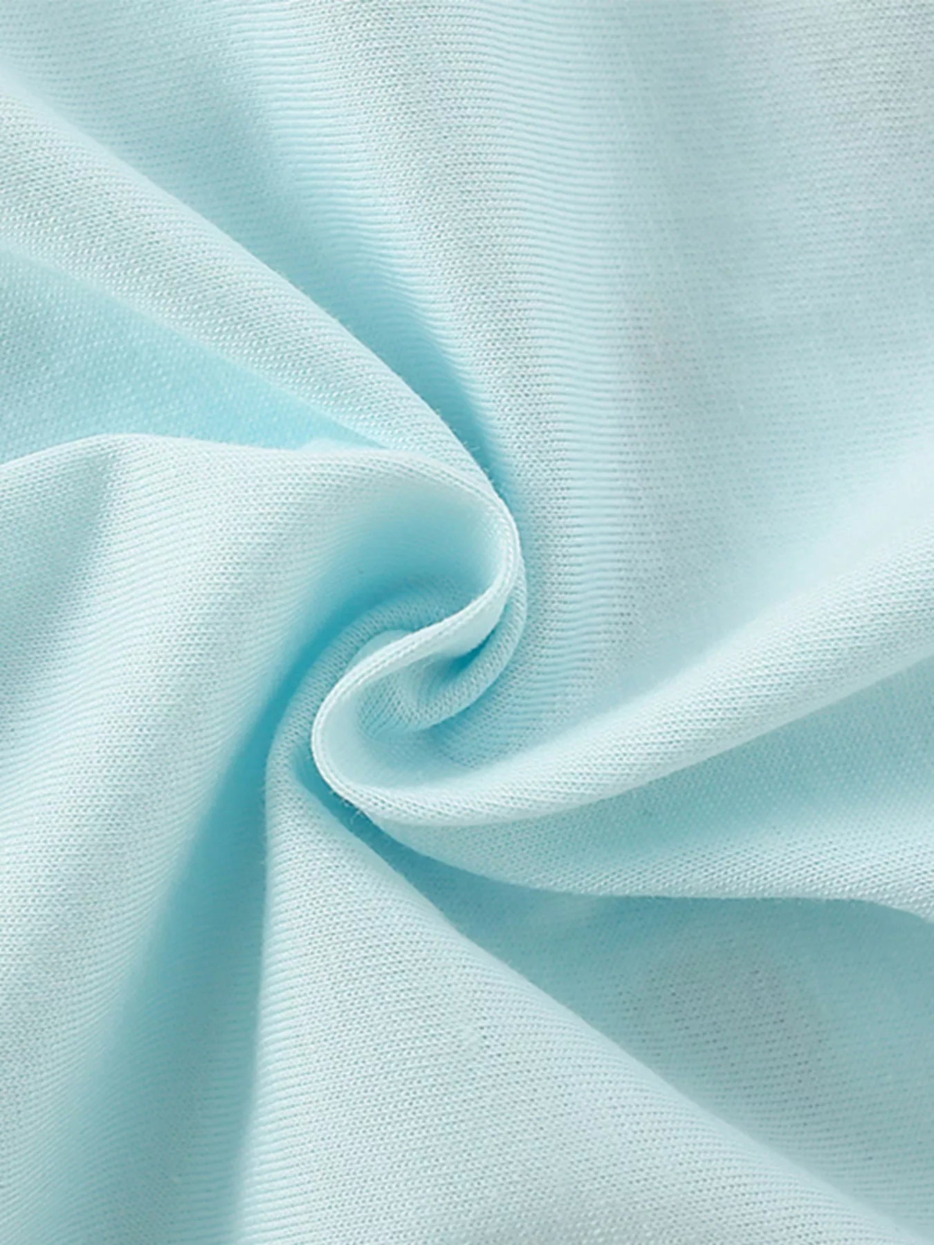 Close-up texture of the soft mint blue fabric of the children's short sleeve shirt