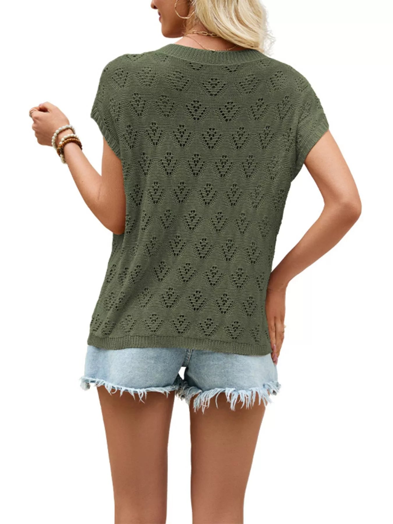 Back view on-model of green openwork short sleeve knit top with heart shaped perforations against plain background
