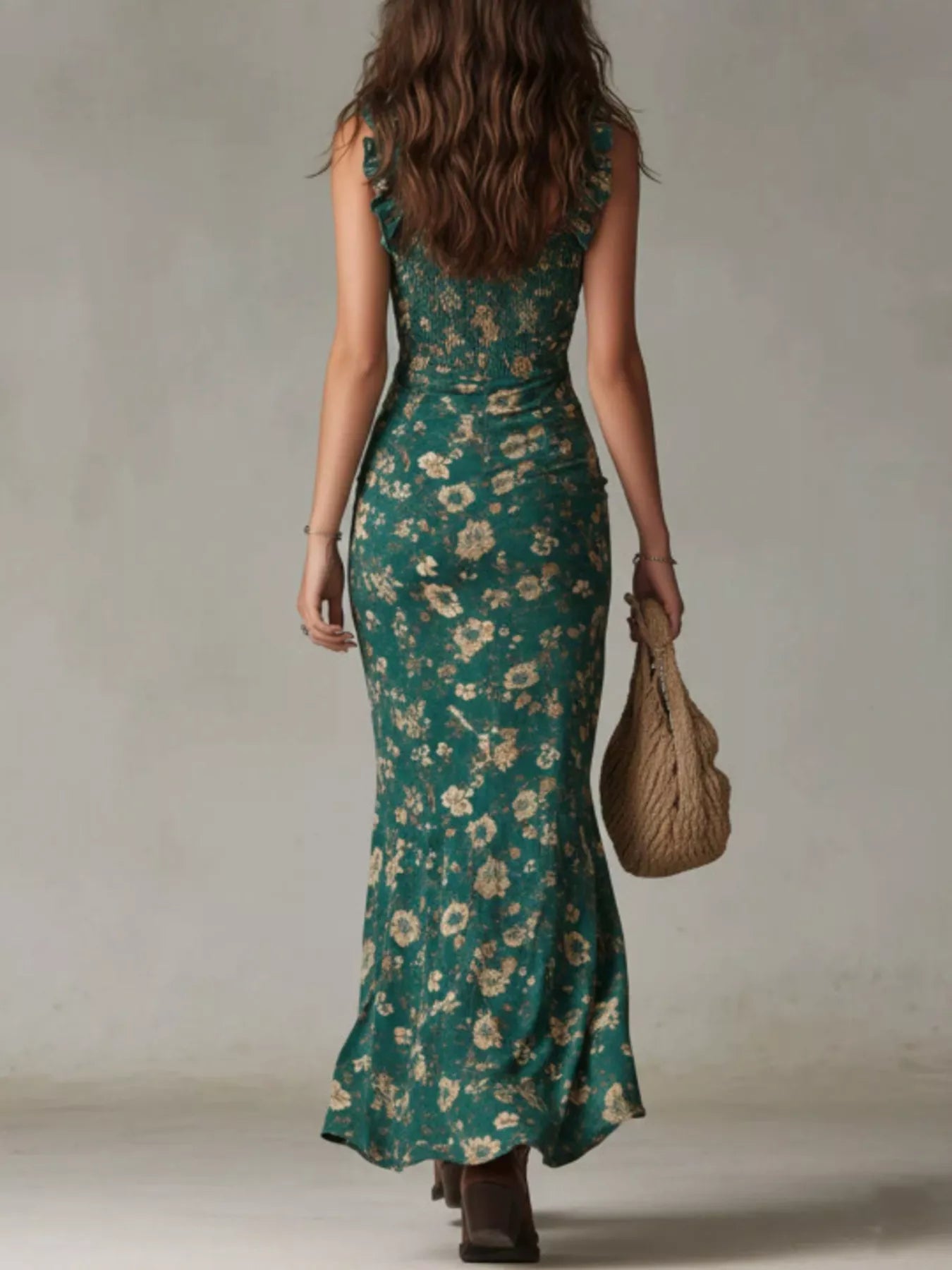 Back view of green floral smocked maxi dress with ruffle straps and flowing skirt