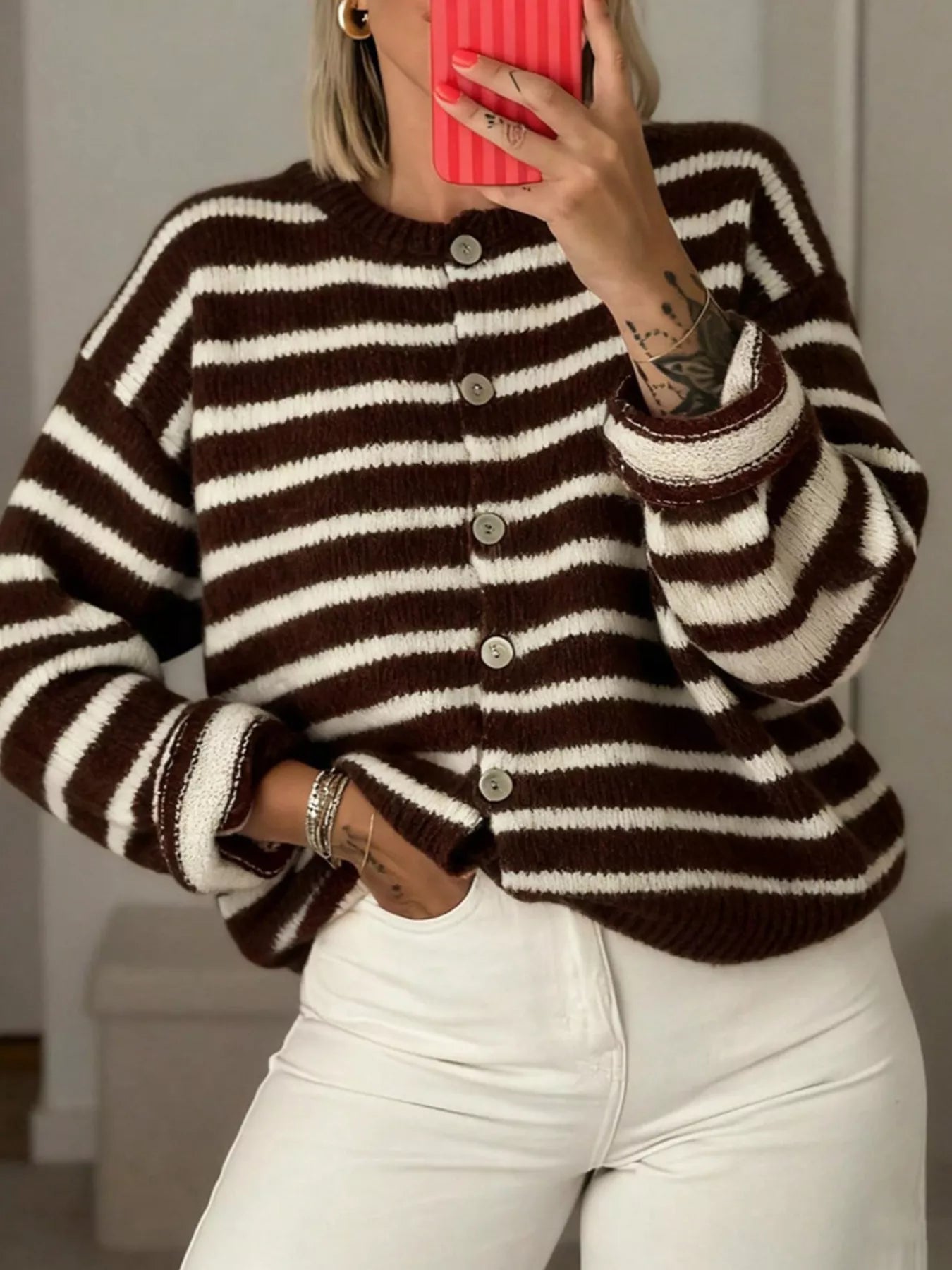 Mirror selfie close up of brown and white striped button down cardigan with white pants