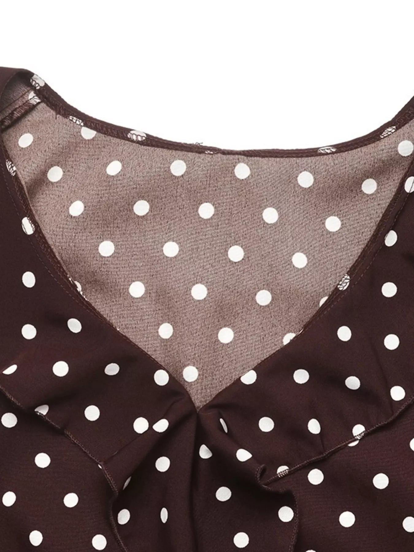 Close-up detail of the coffee brown polka dot bodysuit V neckline and lining