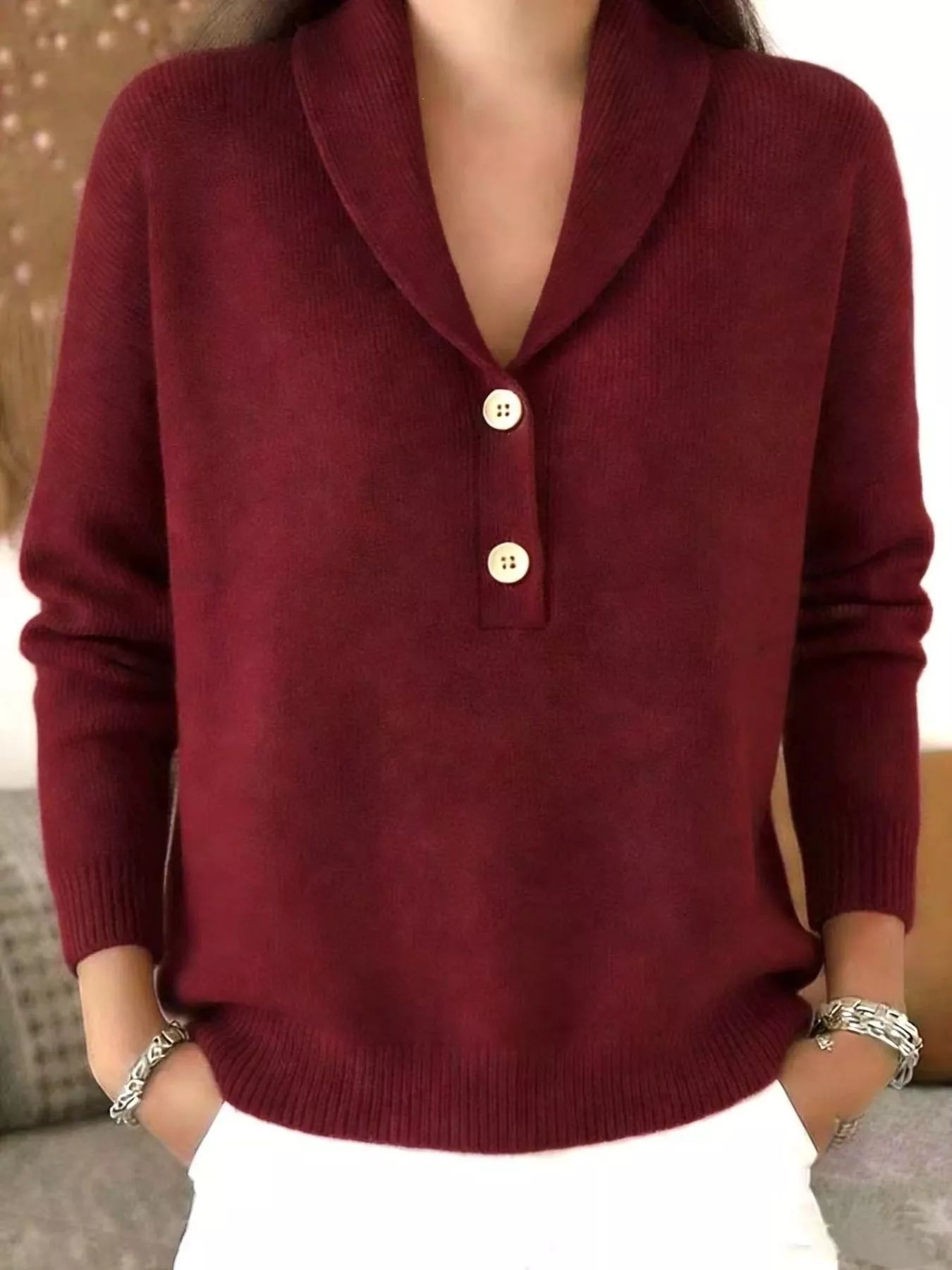 On-model front view of a burgundy shawl collar sweater with cream buttons
