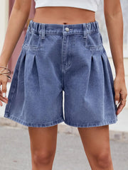 Women's dusty blue denim shorts with ruched detailing, a half-elastic waist, and buttons.