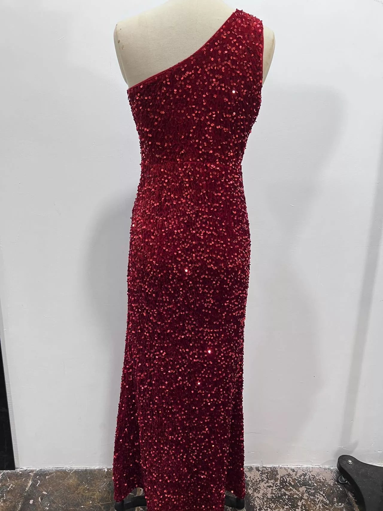 Burgundy sequin one shoulder evening dress shown from the back on a dress form