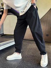 Men's black cotton-blend cargo pants with a drawstring waist and pockets.