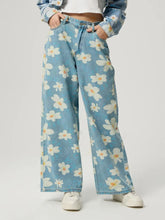 Women's floral wide-leg jeans with buttons and pockets.