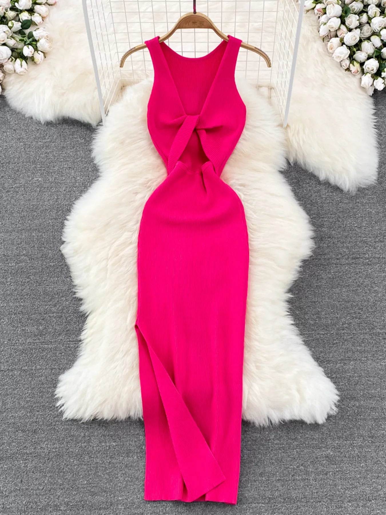 Rose red sleeveless knit bodycon midi dress, back view with knotted open back on hanger