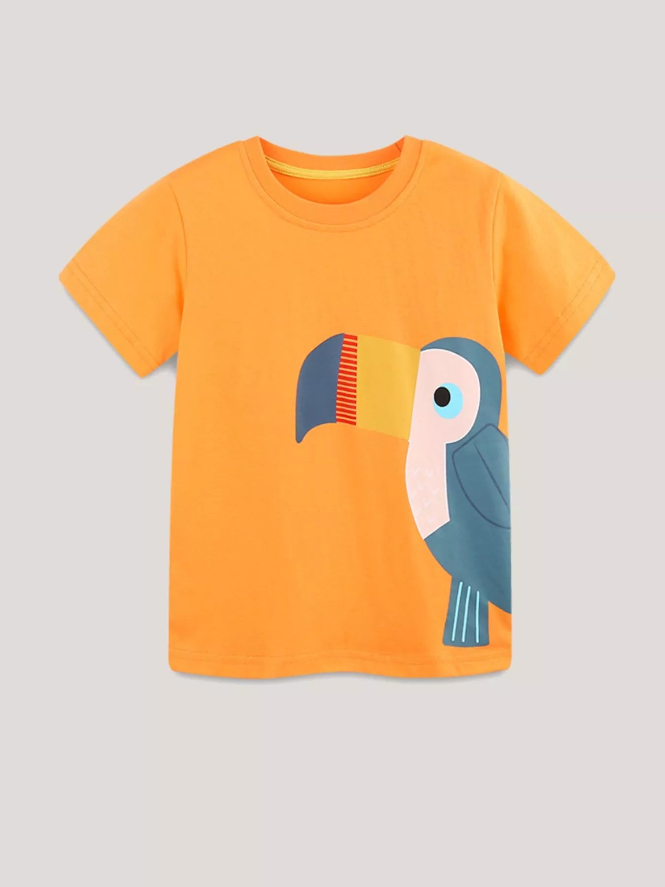 Flat lay front view of orange children's round neck tee with toucan printed down one side