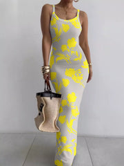 Grey sleeveless bodycon maxi dress with bold yellow floral print worn front facing