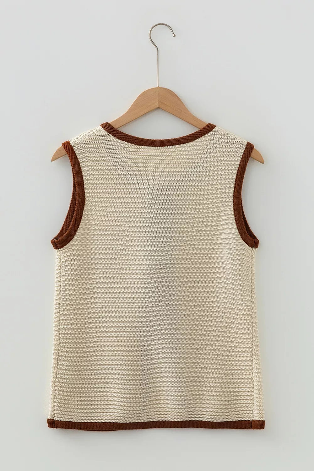 Flat lay back view of a beige tie front sweater vest with brown contrast trim