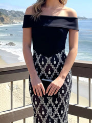 Close front view of black off shoulder bodice and rhinestone skirt at the beach