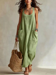 Model wearing light green sleeveless scoop neck maxi dress, full view with large front pockets
