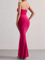 Model wearing strapless rose red tube maxi dress, back view in studio