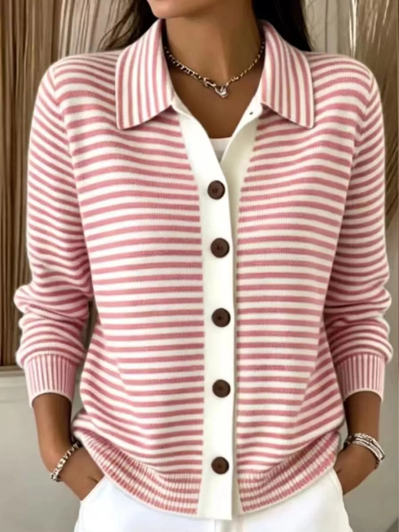 On-model front view of a pink and white striped button-down knit cardigan with a collar