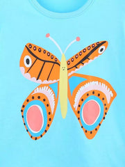 Close-up detail of the orange butterfly graphic with patterned wings on blue fabric