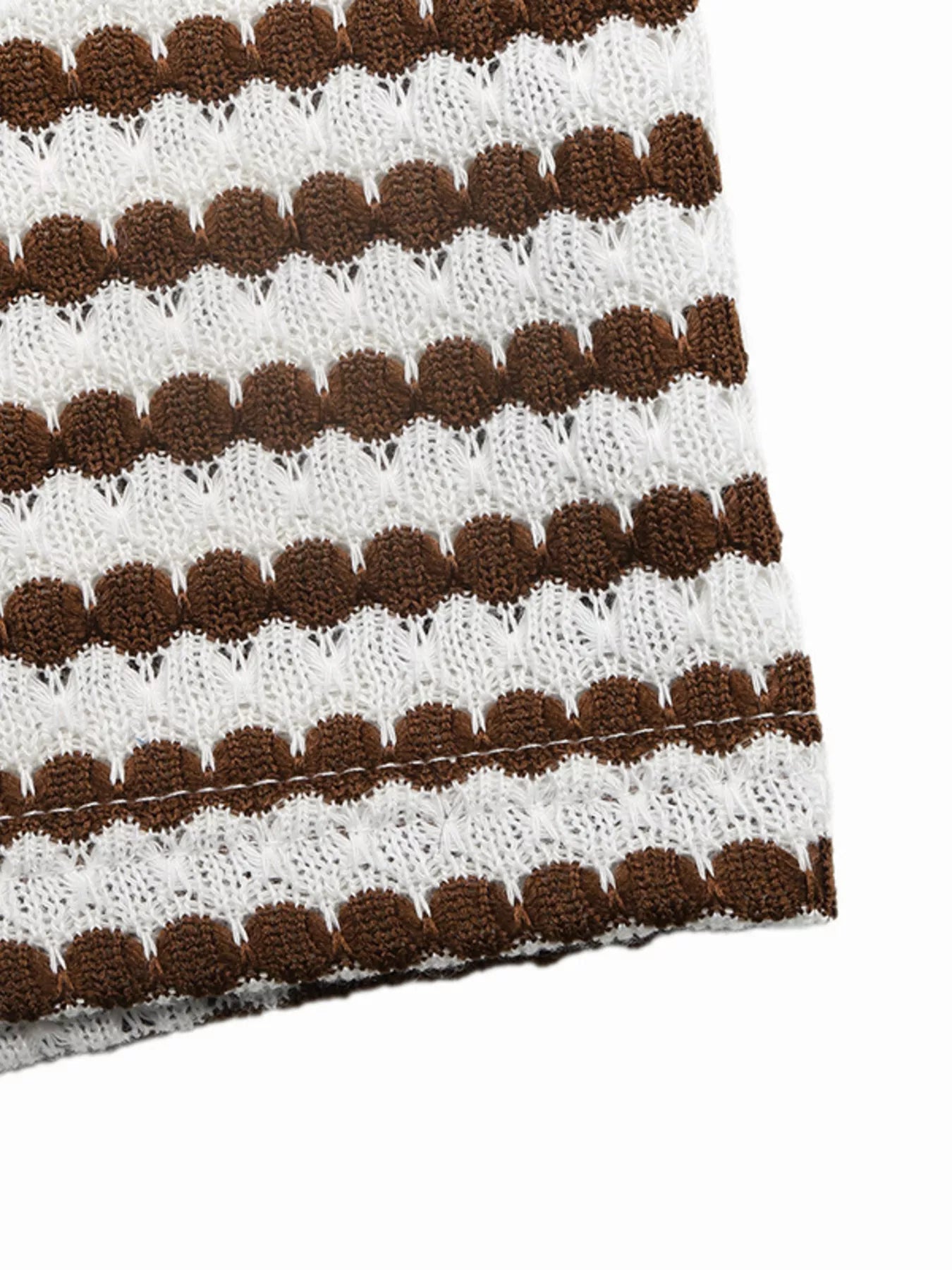 Close up of brown and white striped knit fabric and stitched hem of sleeveless bodycon dress