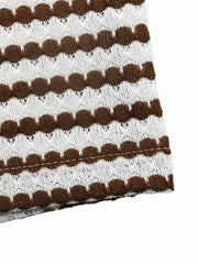 Close up of brown and white striped knit fabric and stitched hem of sleeveless bodycon dress