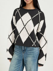 Cropped on-model front view of the black and cream argyle sweater showing the diamond pattern