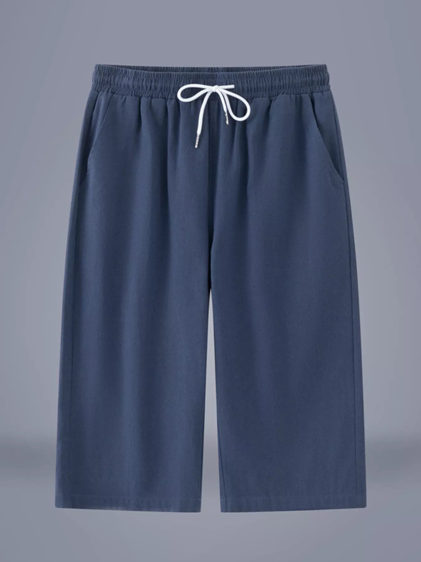 Men's dark blue cropped casual pants with a drawstring waist and pockets.