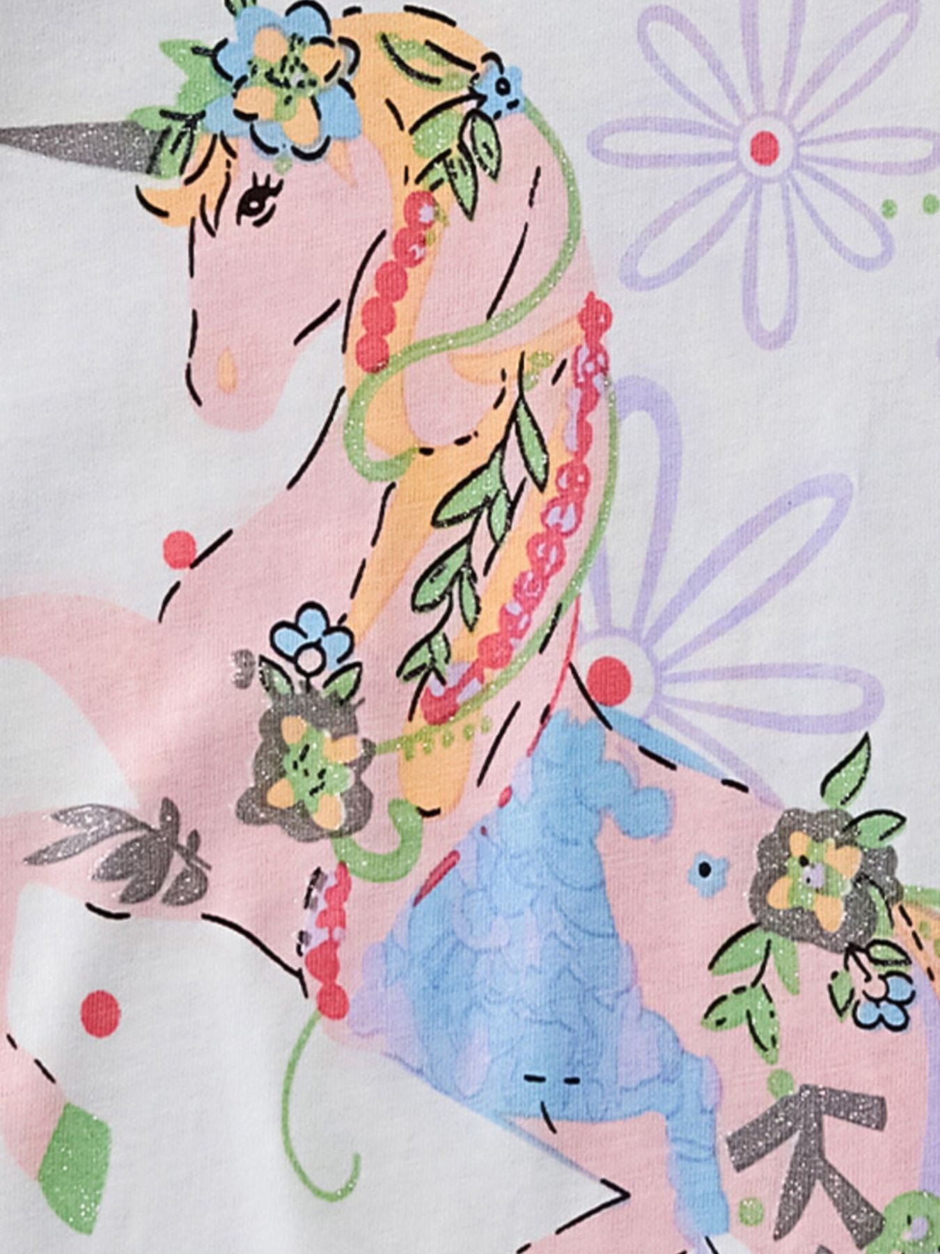 Close view of the pink unicorn with flowers and purple blooms on the white children's tee