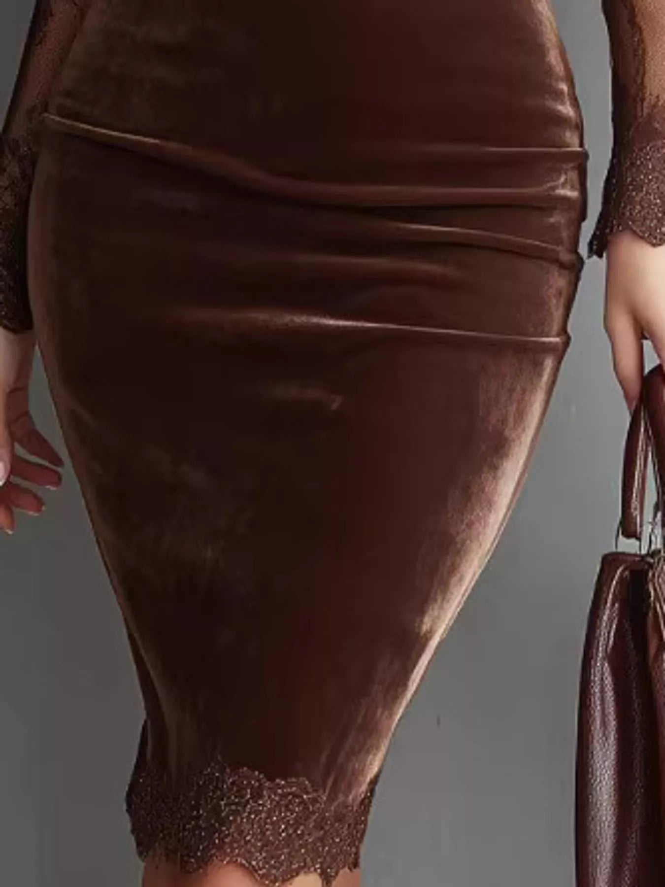 Detail view of the velvet skirt and lace hem of a coffee long sleeve bodycon dress