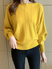 Close front view of the yellow batwing sleeve knit top with vertical seams and ribbed hem.