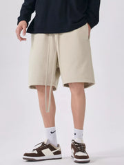 Men's beige casual shorts with a drawstring waist.