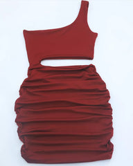 Flat lay view of burgundy one shoulder cutout ruched bodycon mini dress showing the single strap