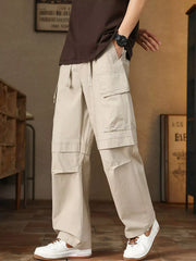 Men's relaxed fit cargo pants with a drawstring waist and pockets.