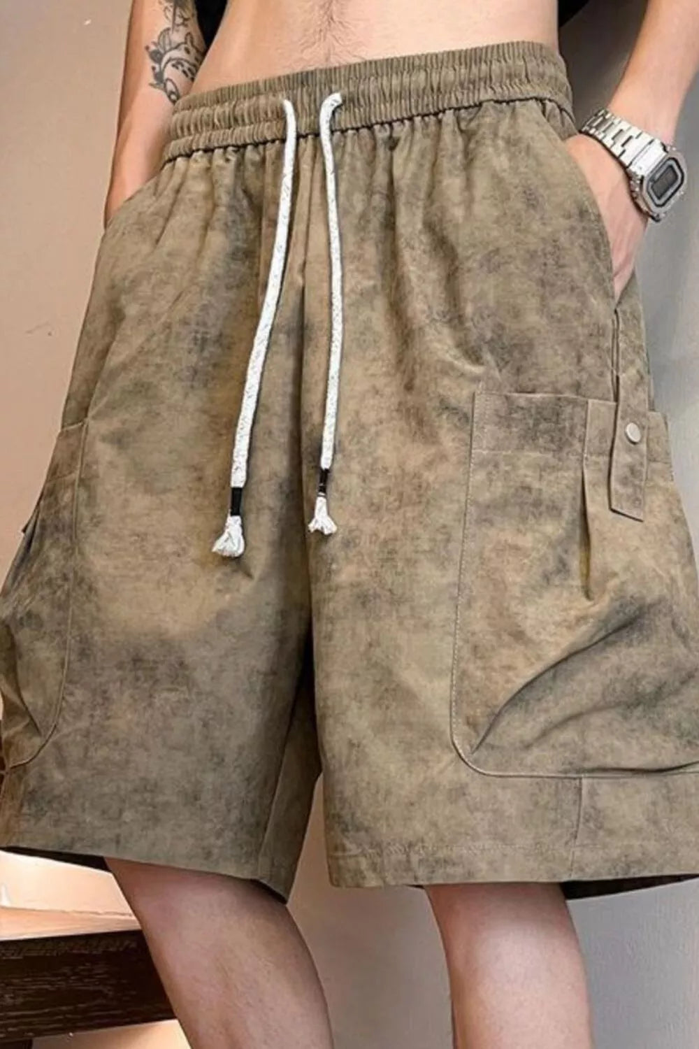 Men's khaki drawstring shorts with pockets and lightweight fabric.