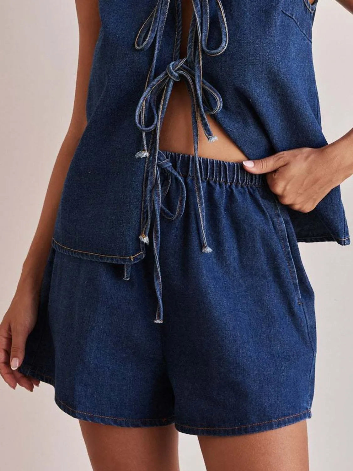 Women's denim shorts with an elastic waistband and tie detail.