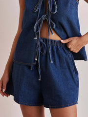 Women's denim shorts with an elastic waistband and tie detail.