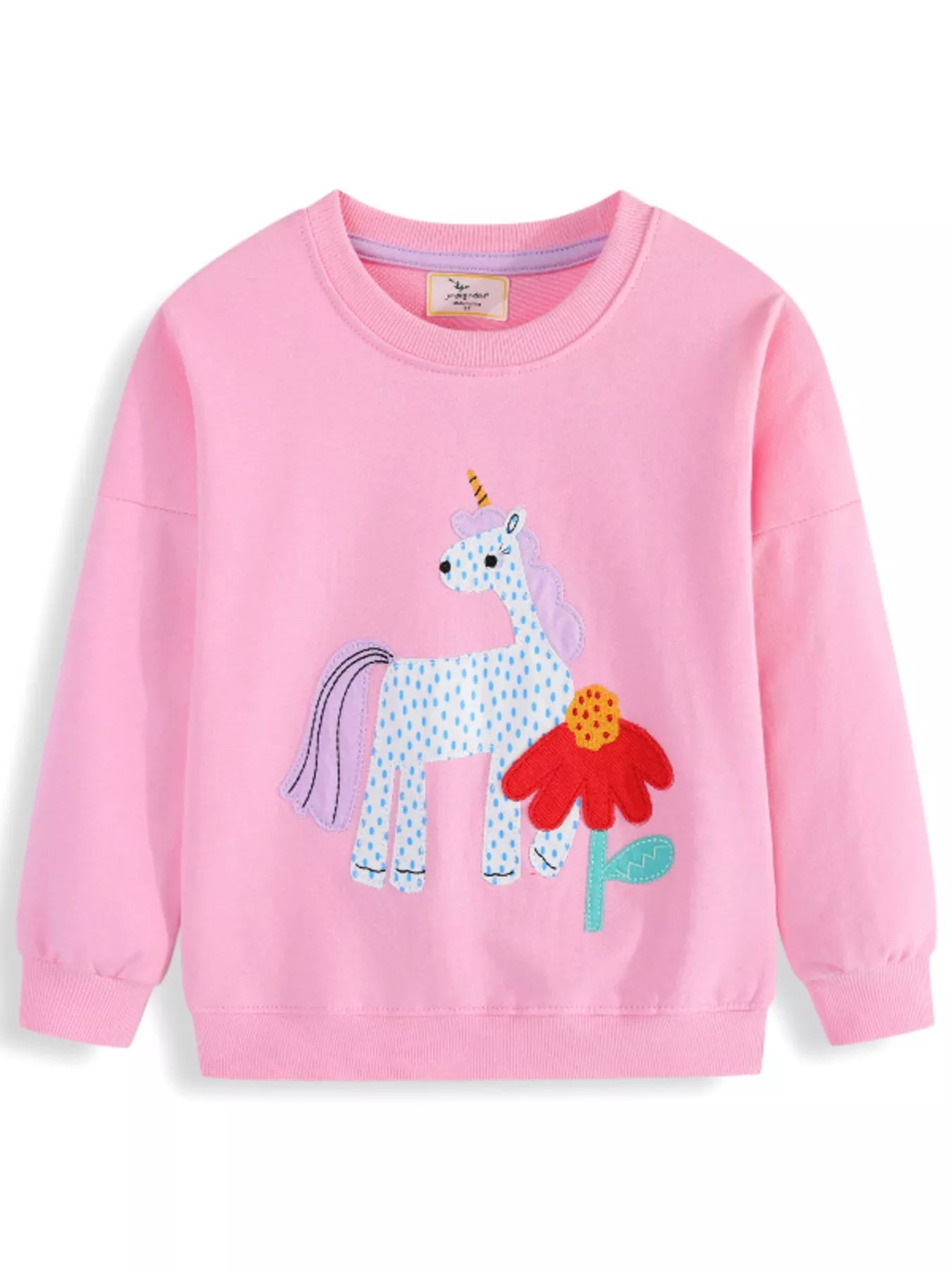 Front view of a pink children's crew neck sweatshirt with a spotted unicorn and red flower patch