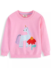 Front view of a pink children's crew neck sweatshirt with a spotted unicorn and red flower patch