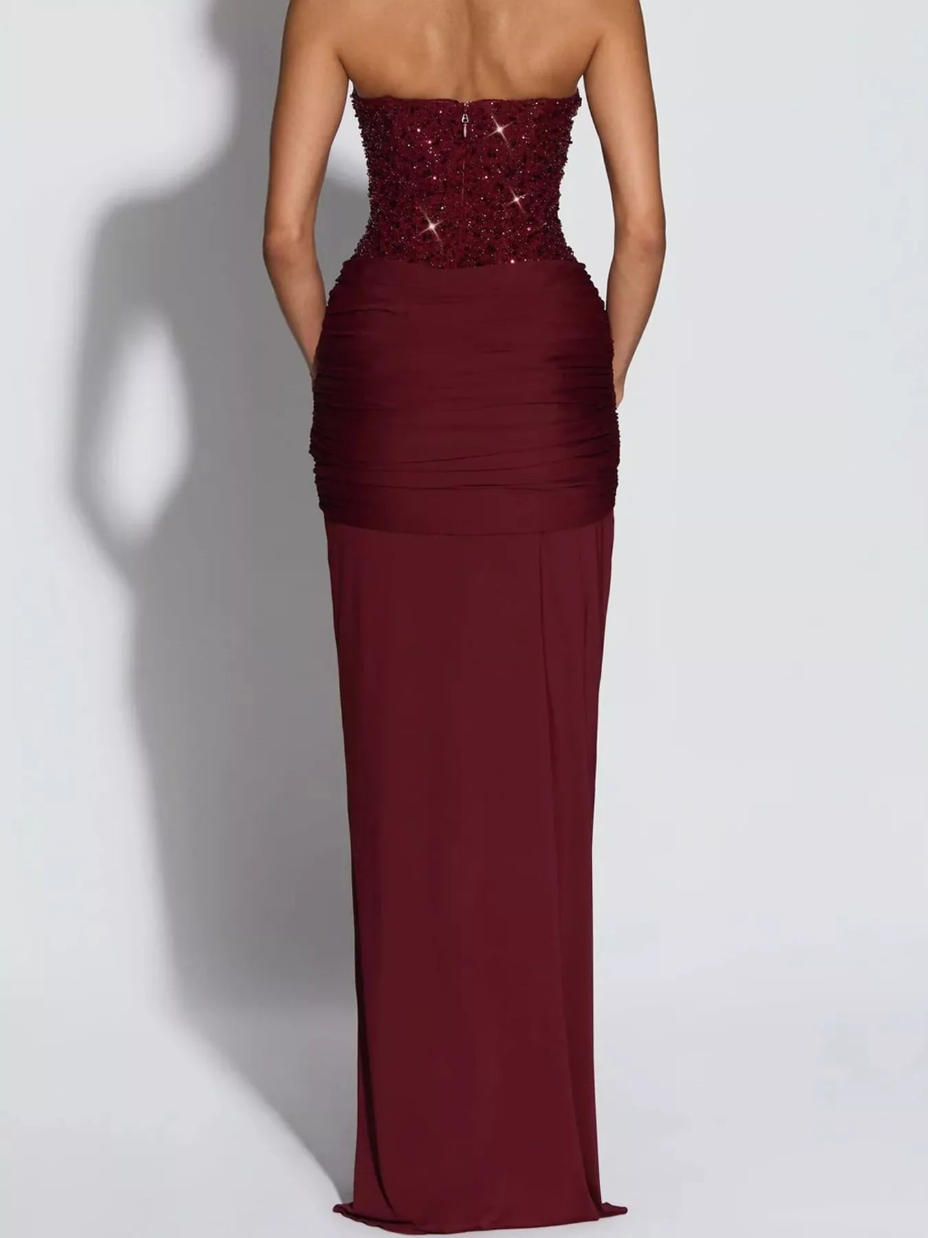 Red strapless sequin corset maxi dress on model, full length back view showing zip