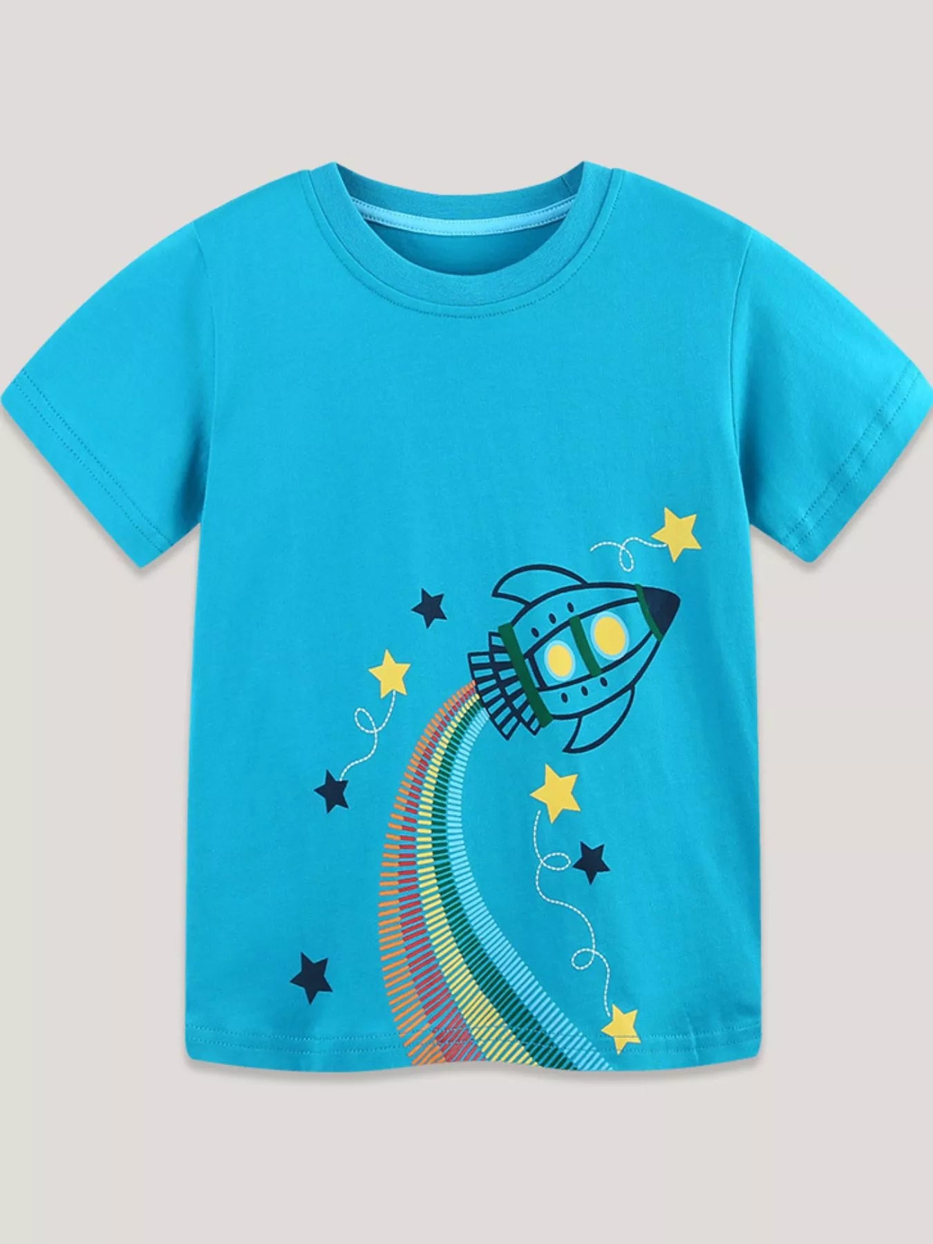 Sky blue children's round neck T-shirt with a rocket graphic trailing a rainbow trail among stars