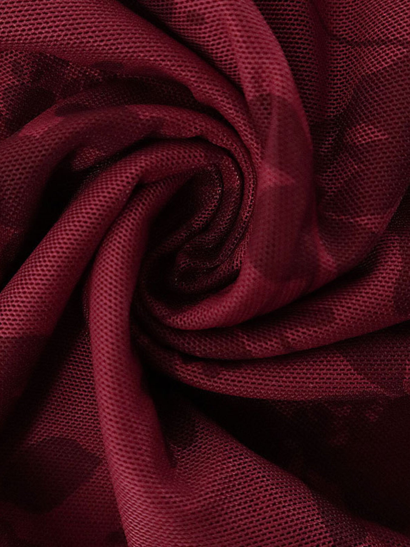 Burgundy floral mesh fabric swirl close up showing texture and pattern of mini dress