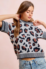 Front view of a light gray leopard print knit top with striped collar and cuffs.