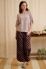 Full length front view of washed mocha dolman knit top with wide trousers.