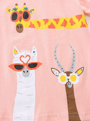 Close-up of cartoon animal prints with giraffe llama and antelope wearing novelty glasses on pink fabric