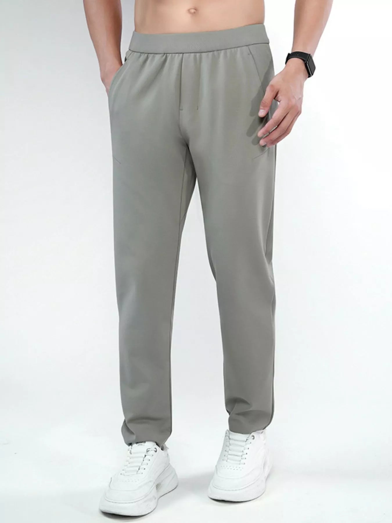 Men's dark gray slim-fit pants with a drawstring waist and pockets.