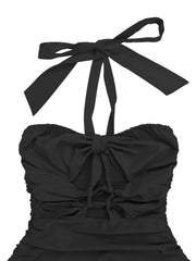 Close up of black halter maxi dress bodice showing knotted ties and smocked back panel