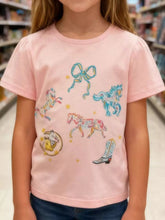 Front view of a pink children's tee with colourful horses a bow a cowboy boot and stars