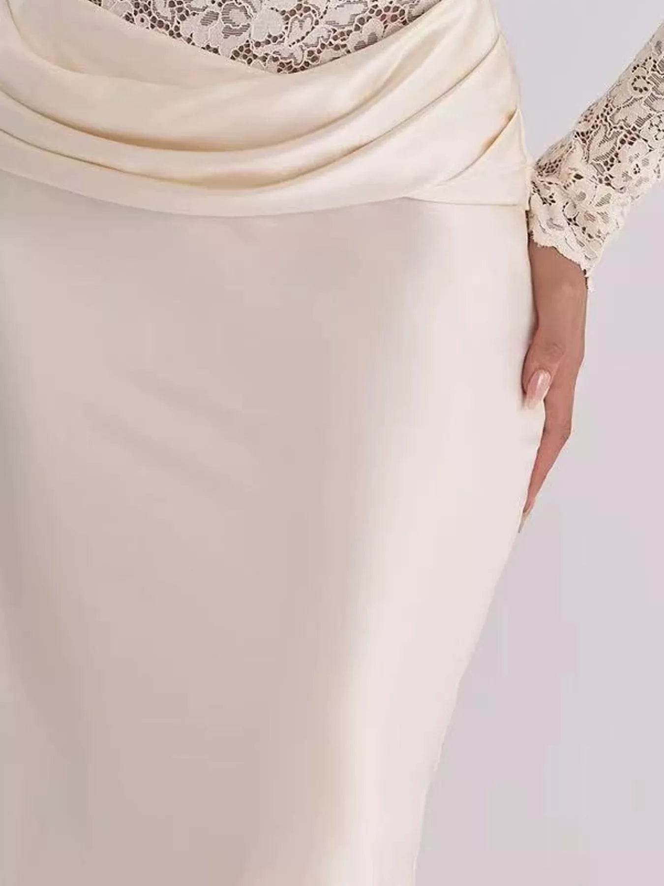 Close detail of ivory draped satin waist and lace sleeve on maxi dress