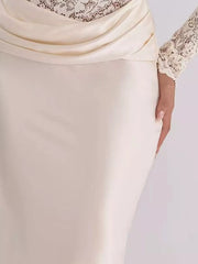 Close detail of ivory draped satin waist and lace sleeve on maxi dress