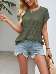 On-model front view of green openwork short sleeve knit top with heart shaped perforations outdoors