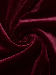 Close view of burgundy velvet fabric with soft folds from the mini dress