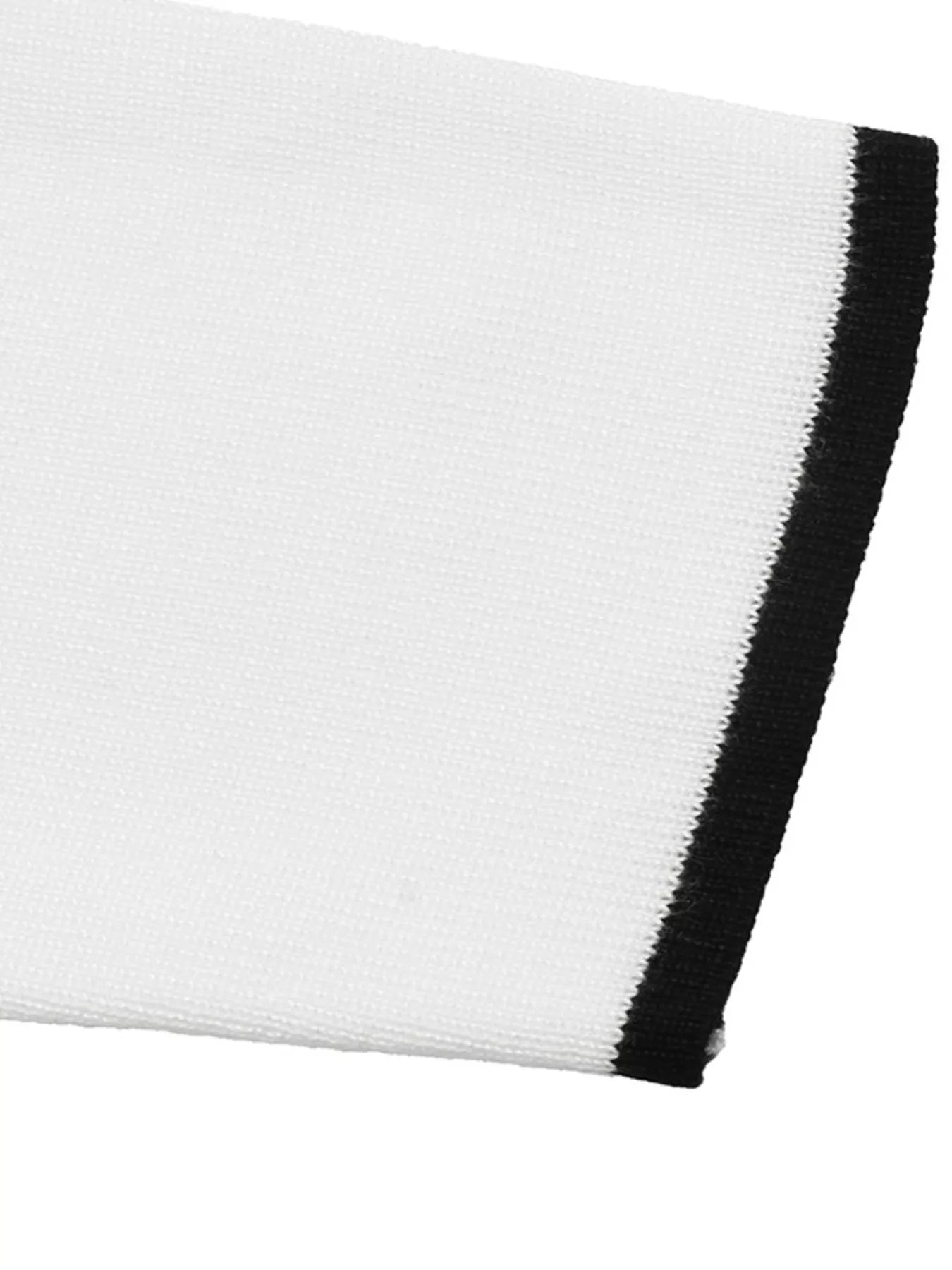 Close up of white knit sleeve cuff with narrow black trim.